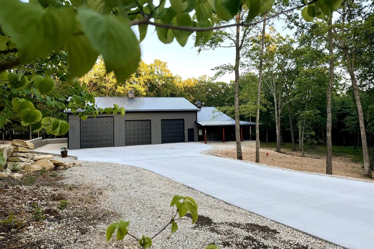 Long wide concrete driveway from the road to the door. You will be surrounded by trees on this magnificent 4-acre lot.