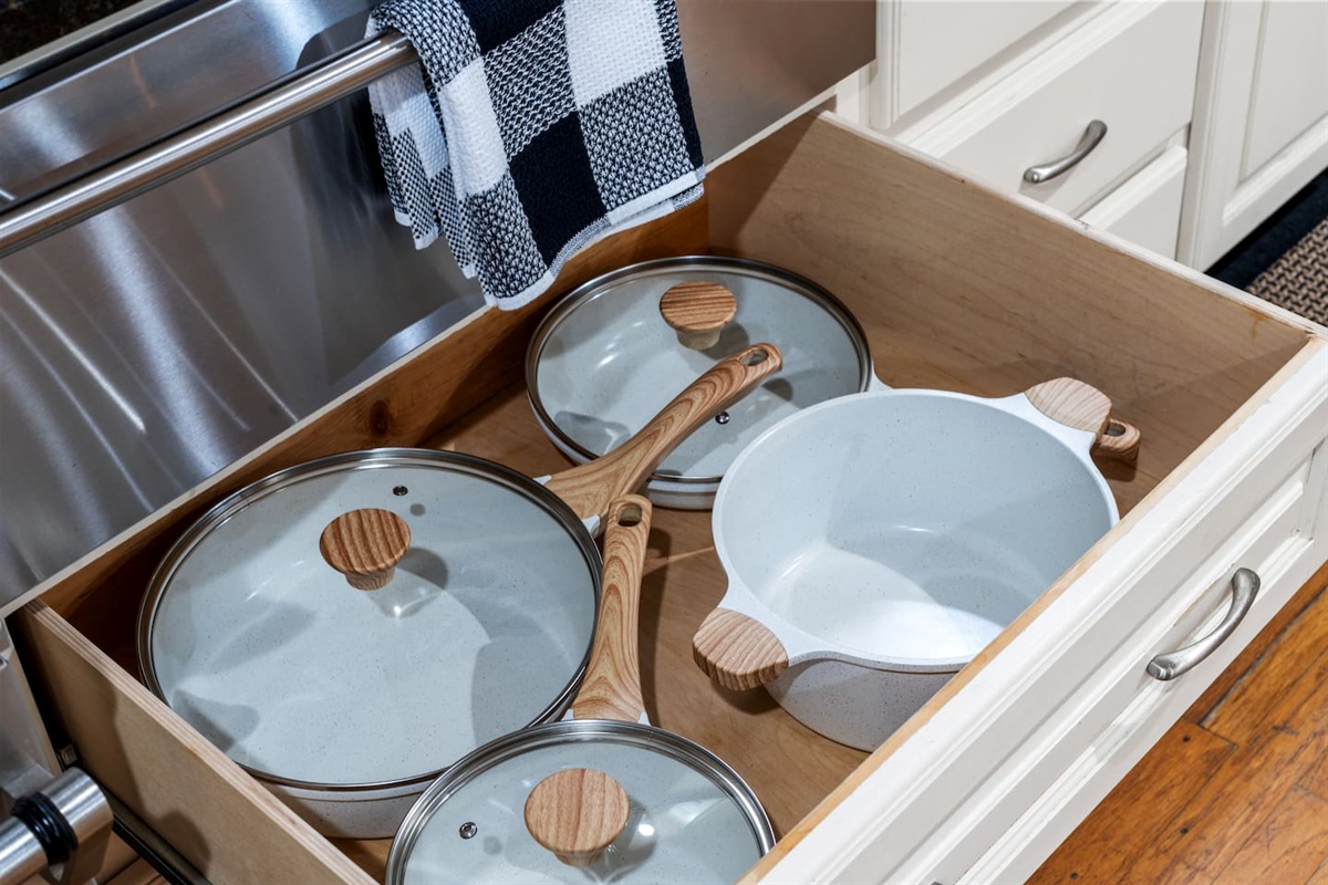 Cookware that blends function and style — non-stick pots and pans with a clean, wood-accented finish.