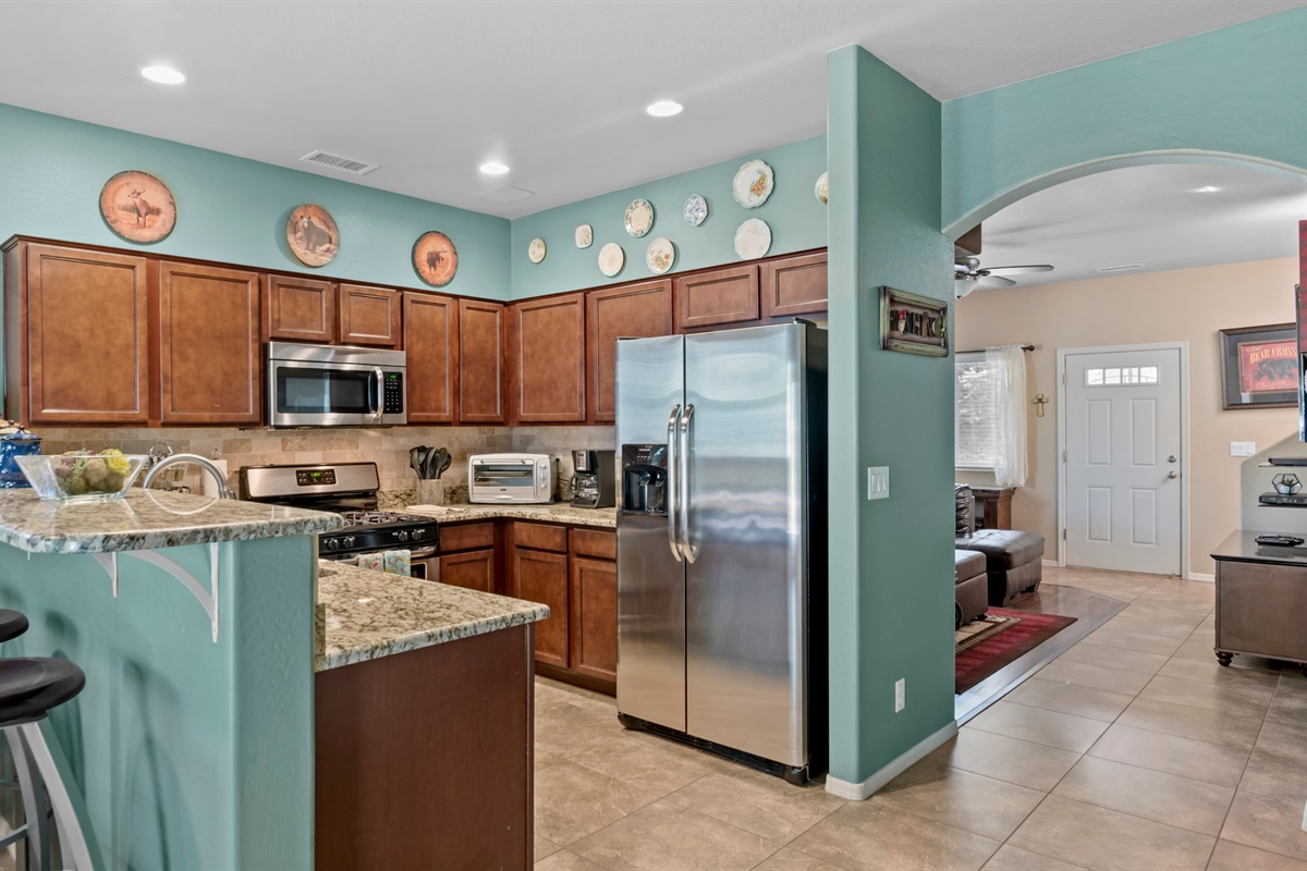 Gather at the breakfast bar, perfect for quick bites or morning coffee, with a view of the welcoming front door.