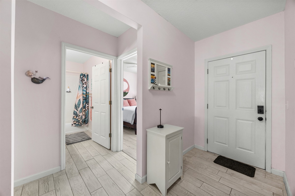 Clean, airy hallway connecting bedrooms and bathroom, accented with soft colors and thoughtful décor.