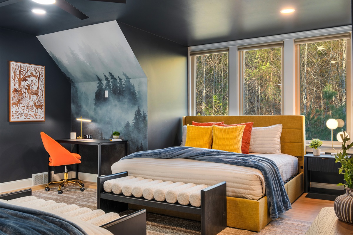 Bedroom with workspace and multiple windows - great balance of comfort and functionality