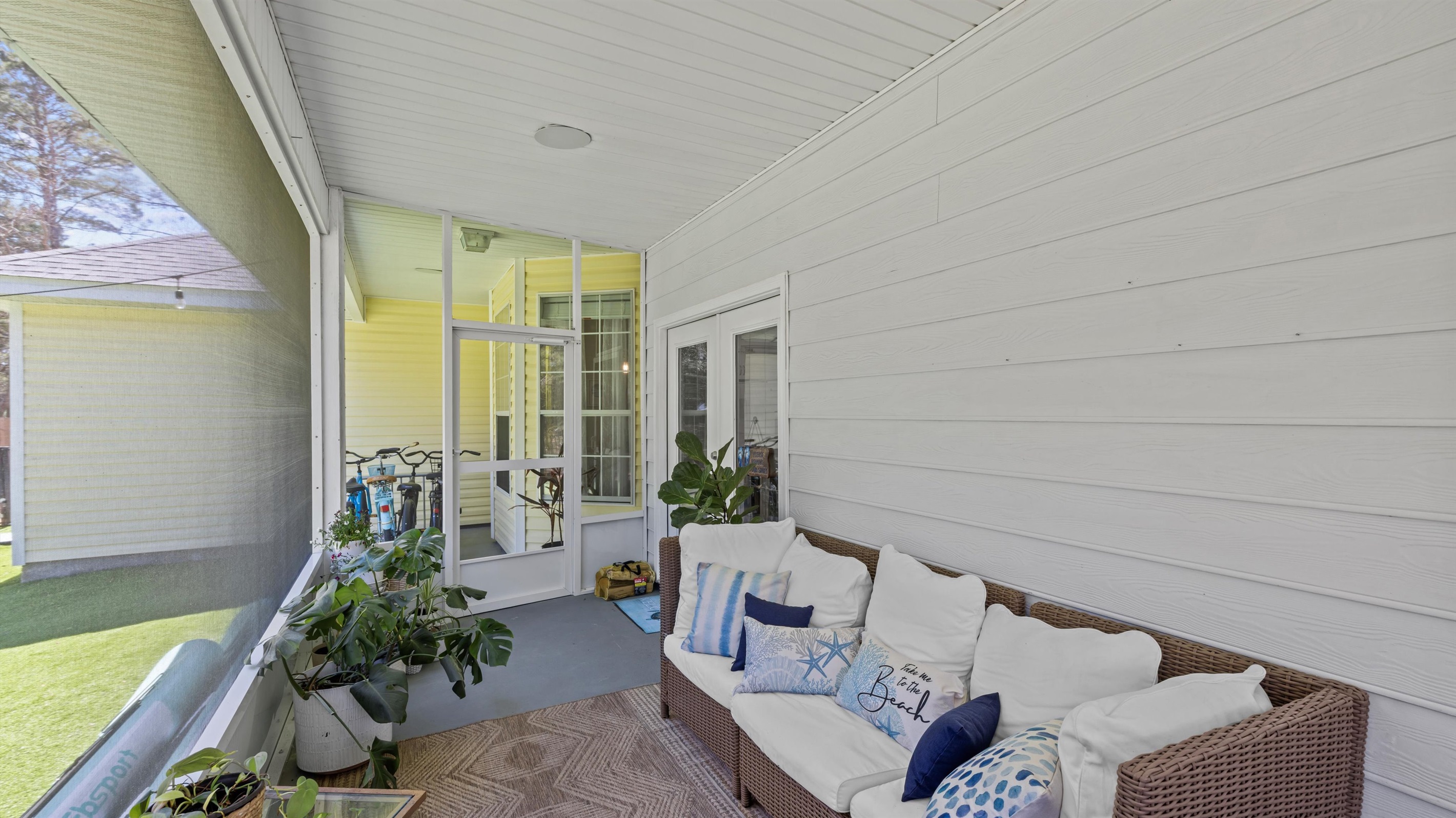 The screened porch with seating for everyone is your go-to for laid-back meals, cozy hang outs, and evening breezes without the bugs.