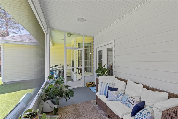 The screened porch with seating for everyone is your go-to for laid-back meals, cozy hang outs, and evening breezes without the bugs.