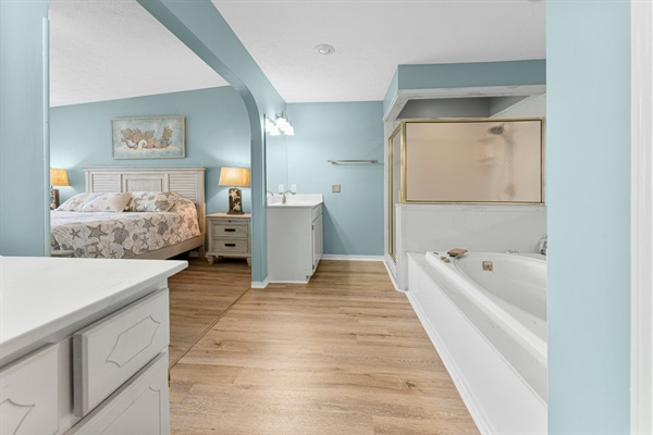 Bedroom #1 with king bed, ceiling fan, smart TV and ensuite bathroom