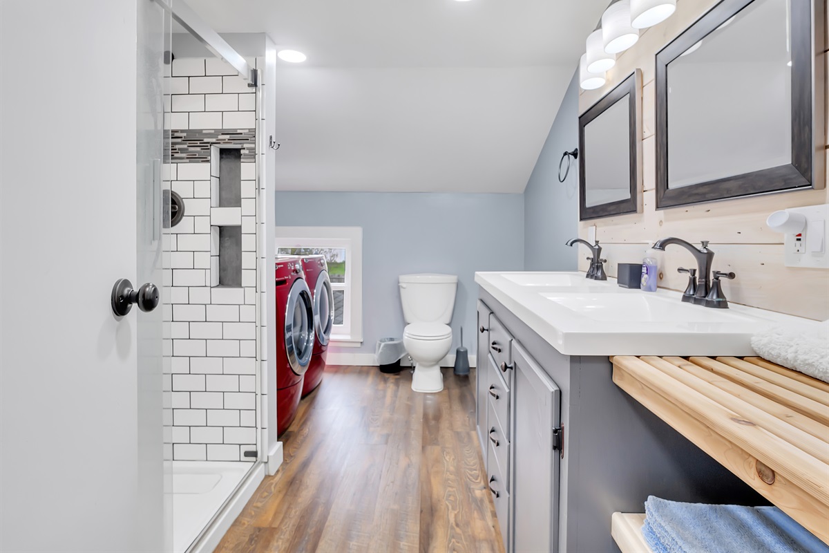 Bathroom with luxury shower and washer and dryer