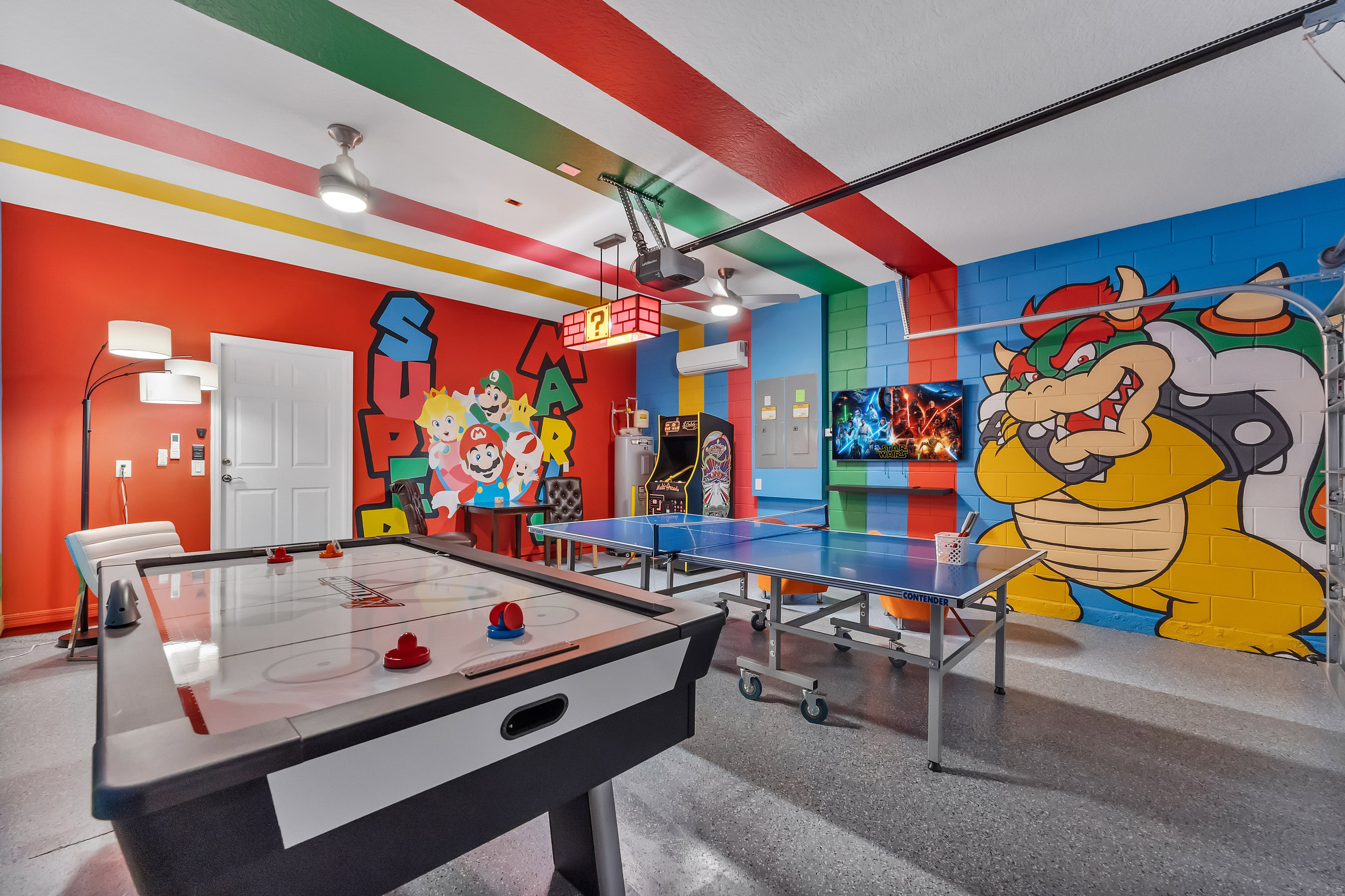 Super Mario Bros. game room with arcade, air hockey, and ping pong.