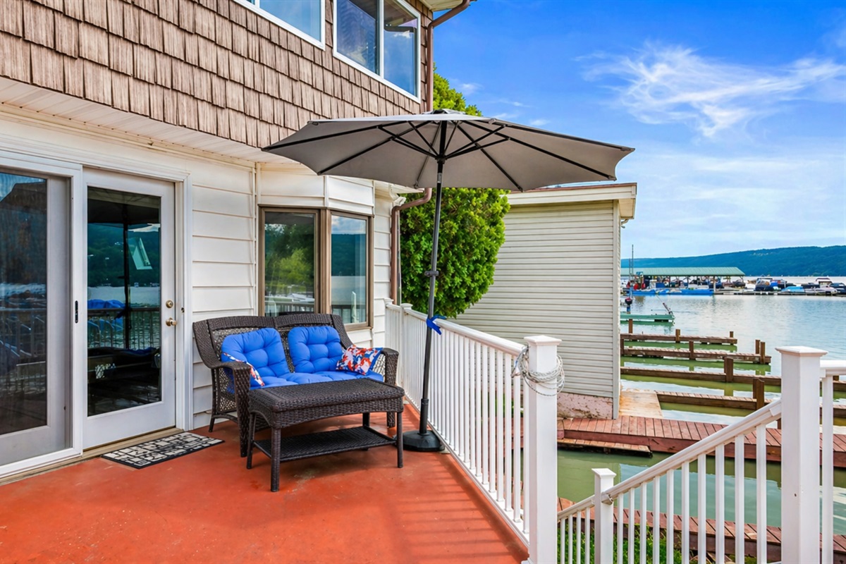 Relax on the cozy lakeside patio with stunning water views and a shaded spot to unwind. Perfect for a peaceful retreat!