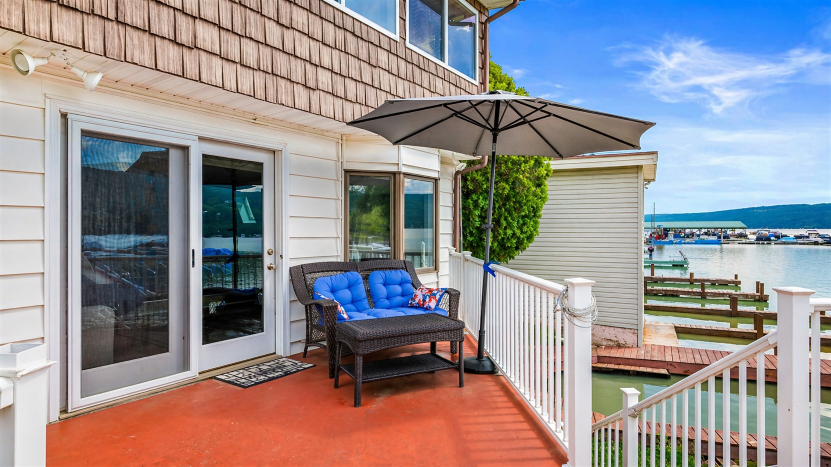 Relax on the cozy lakeside patio with stunning water views and a shaded spot to unwind. Perfect for a peaceful retreat!