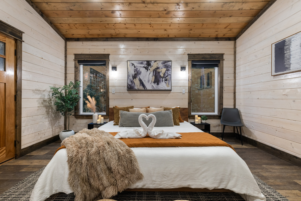 Wake up somewhere that makes you want to stay in bed a little longer. This spacious king retreat was made for slow mornings, quiet nights, and romantic getaways, with the hot tub just steps away through the double doors.