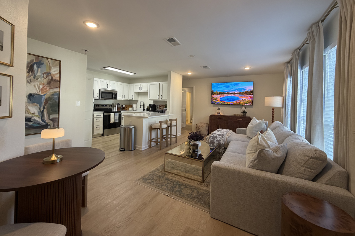 The living room opens to the kitchen and dining nook, so the cook never misses the conversation or the game.