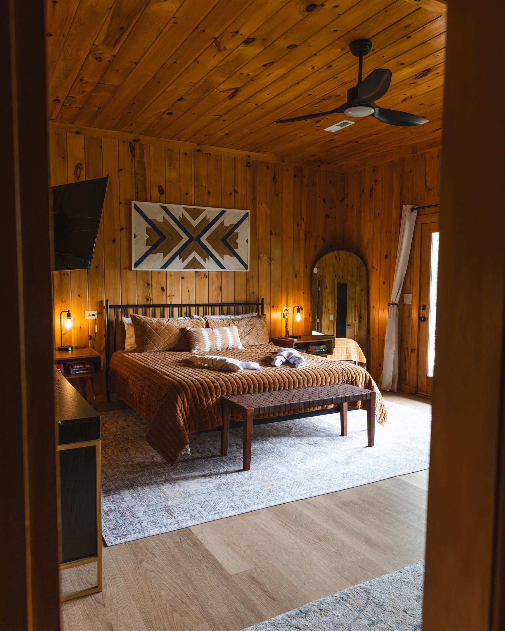 Spacious lower-level master suite designed for comfort, privacy, and relaxation. Featuring a plush king bed, this quiet cabin retreat includes a Roku TV, dresser, closet, futon, and reading chair - everything you need for a restful and convenient stay.
