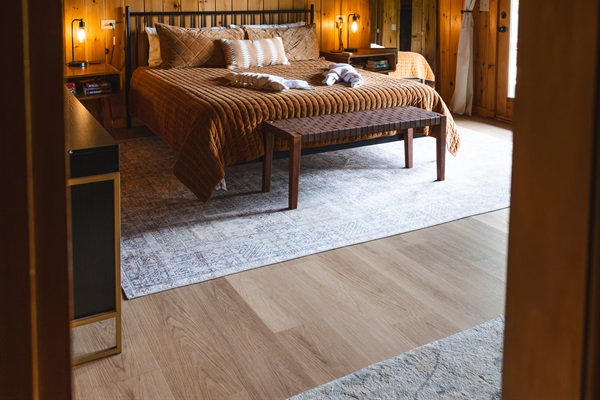 Spacious lower-level master suite designed for comfort, privacy, and relaxation. Featuring a plush king bed, this quiet cabin retreat includes a Roku TV, dresser, closet, futon, and reading chair - everything you need for a restful and convenient stay.