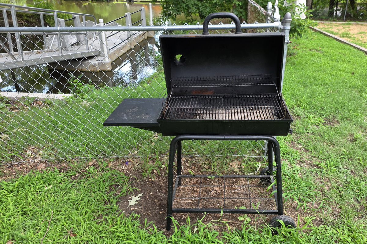 Grill up some meats on the charcoal grille  in the backyard