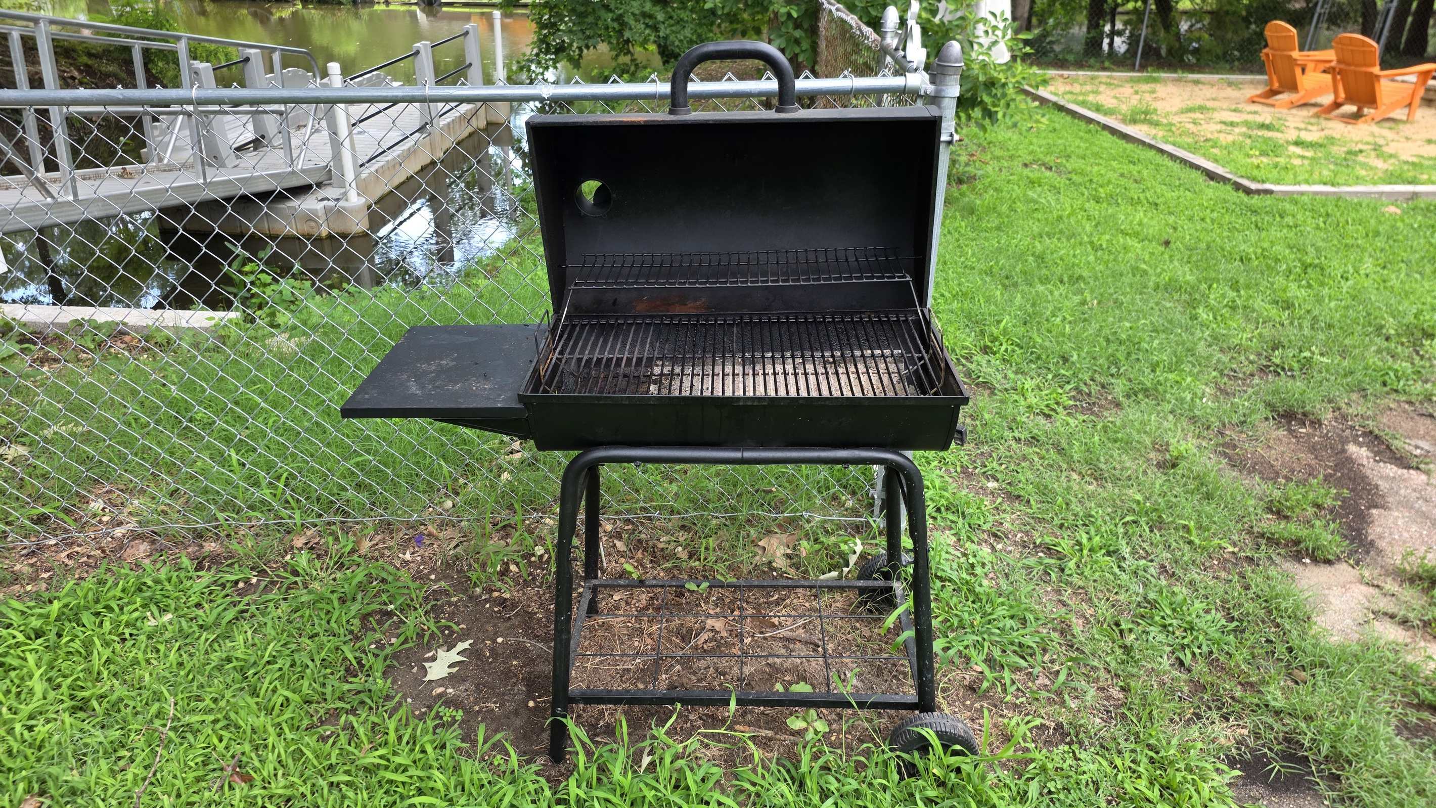 Grill up some meats on the charcoal grille  in the backyard
