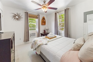 Queen bed with amazing windows and towel decoration