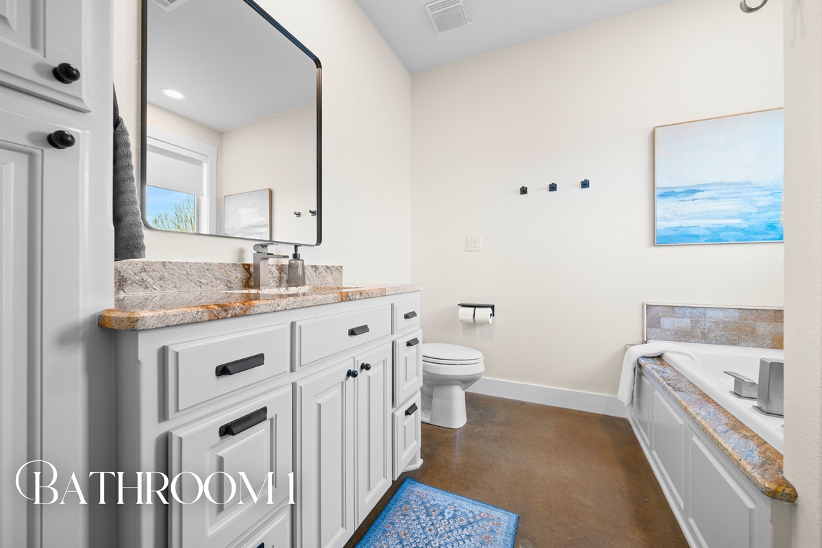 The spacious bathroom offers dual vanities and plenty of room to get ready comfortably, whether you&rsquo;re heading out or winding down.