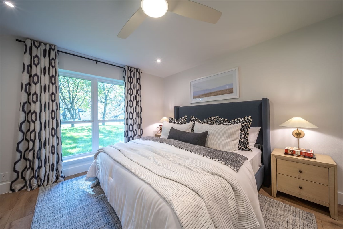 Bedroom 2 provides a spacious layout, natural light, and a serene connection to the outdoors. Neutral tones and clean lines create a relaxed feel, complemented by a large closet and private ensuite bathroom.