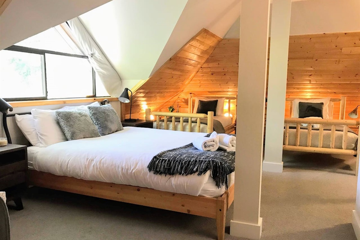 Mountain view Bedroom #4 allows you to check the Blackcomb Gondola queues from the comfort of your own bed. This top floor roost features a new ensuite bathroom & is outfitted w/ 1 queen & 2 twin beds, A/C,  Smart TV
The ultimate family room