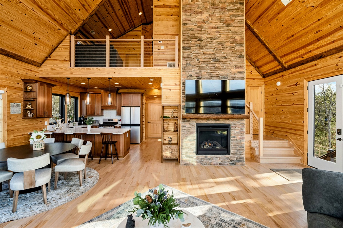 Lodge Living – Dramatic stonework, soaring ceilings, and natural light make this Great Room unforgettable.
