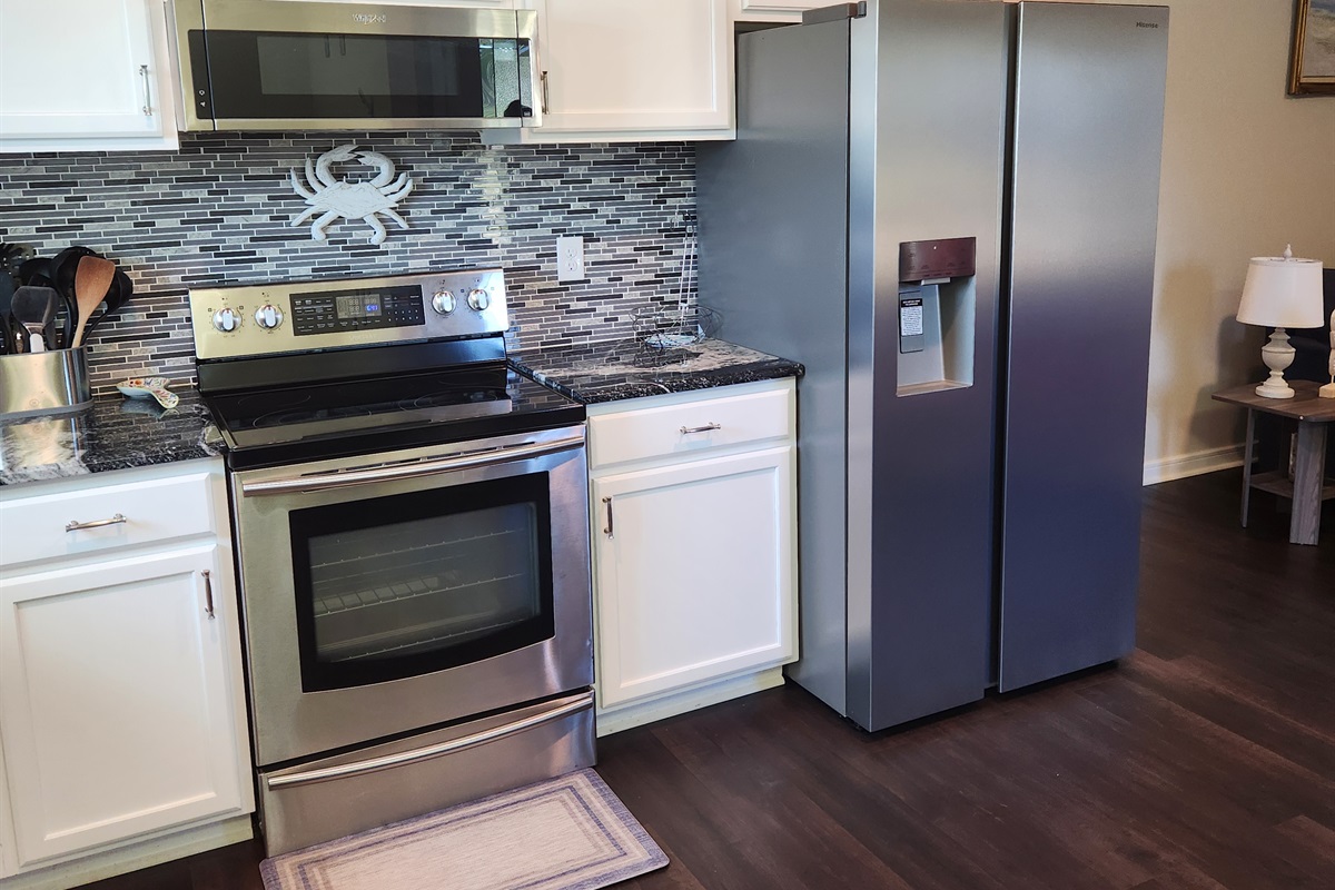 From the sleek refrigerator to the sparkling countertops, this kitchen blends everyday convenience with a splash of style