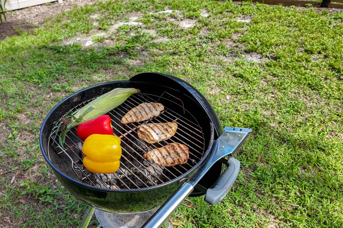 A classic charcoal kettle BBQ sits ready for your grilling adventures.