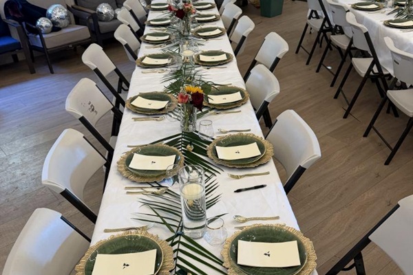 Tables, chairs, multiple pieces of place setting provided