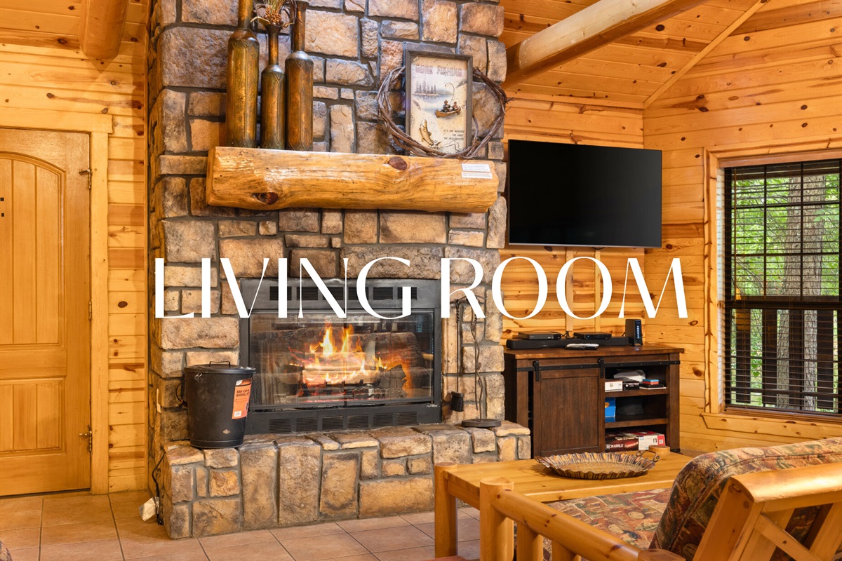 Living room with stone fireplace and cozy cabin vibes.