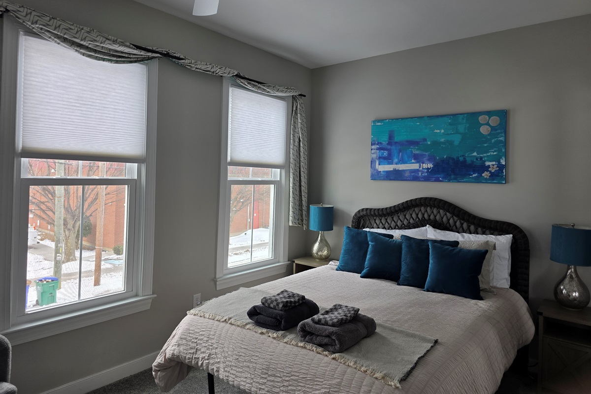 Queen Bedroom 2: Bright space with plush bedding and vibrant accents for a refreshing stay!