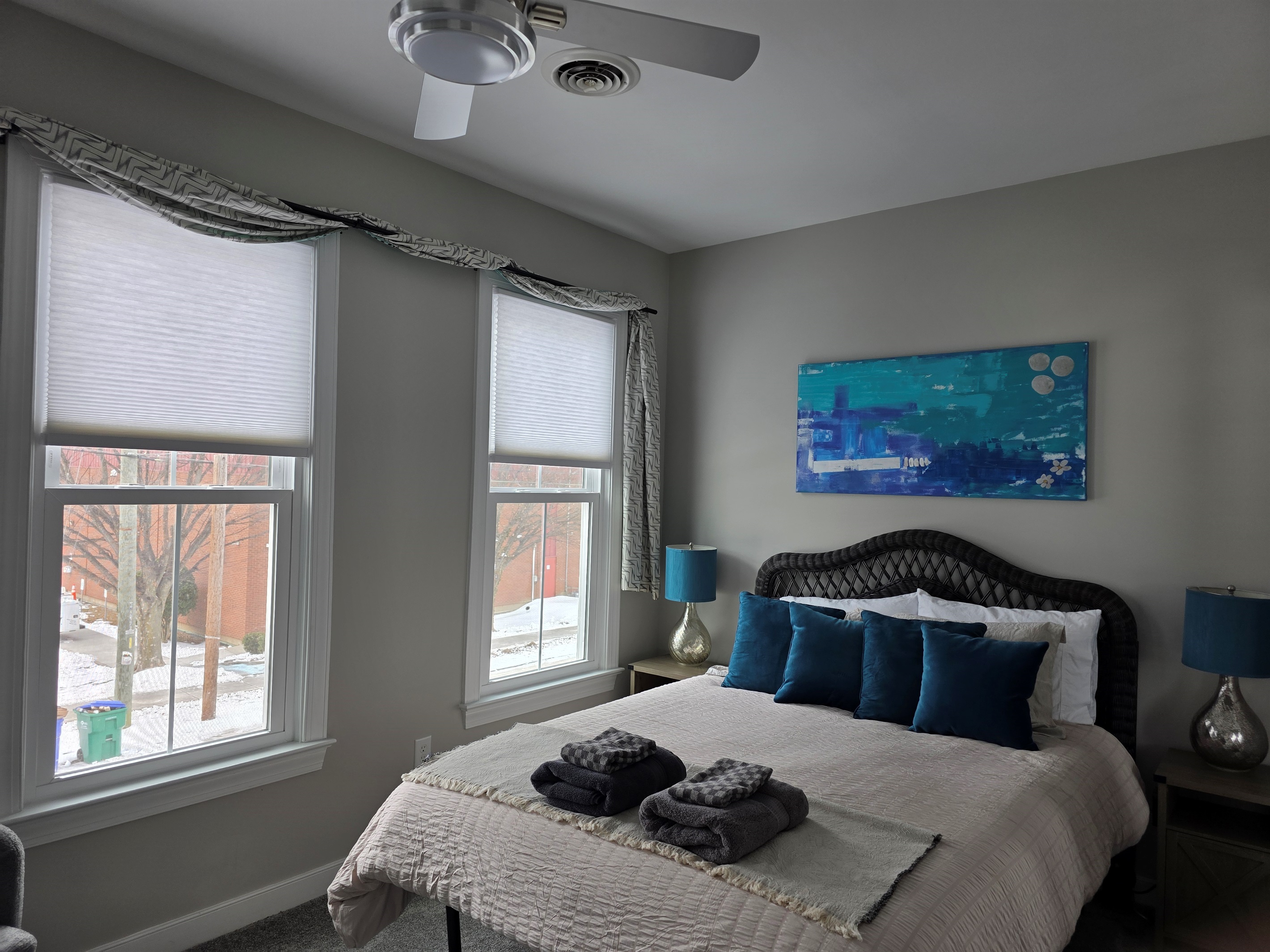 Queen Bedroom 2: Bright space with plush bedding and vibrant accents for a refreshing stay!