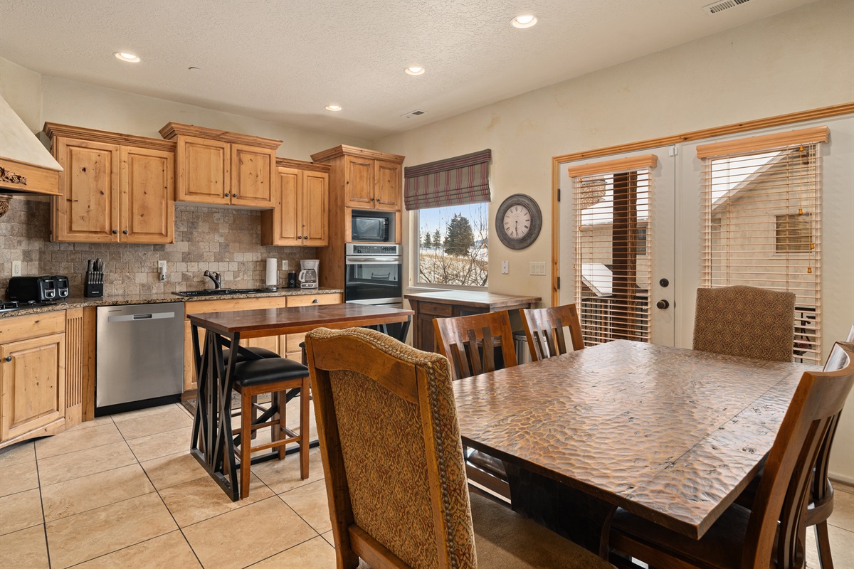Open kitchen with stainless appliances and ample seating