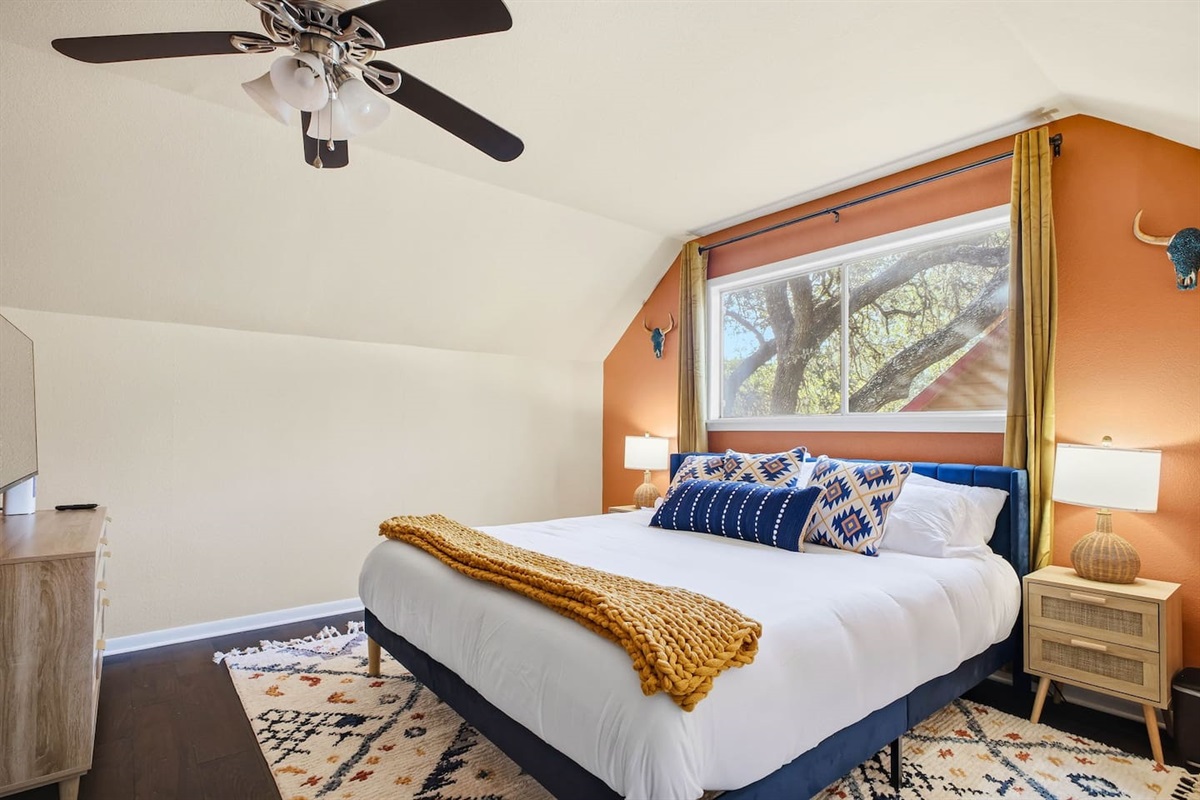 Second-floor bedroom with king bed and Roku TV