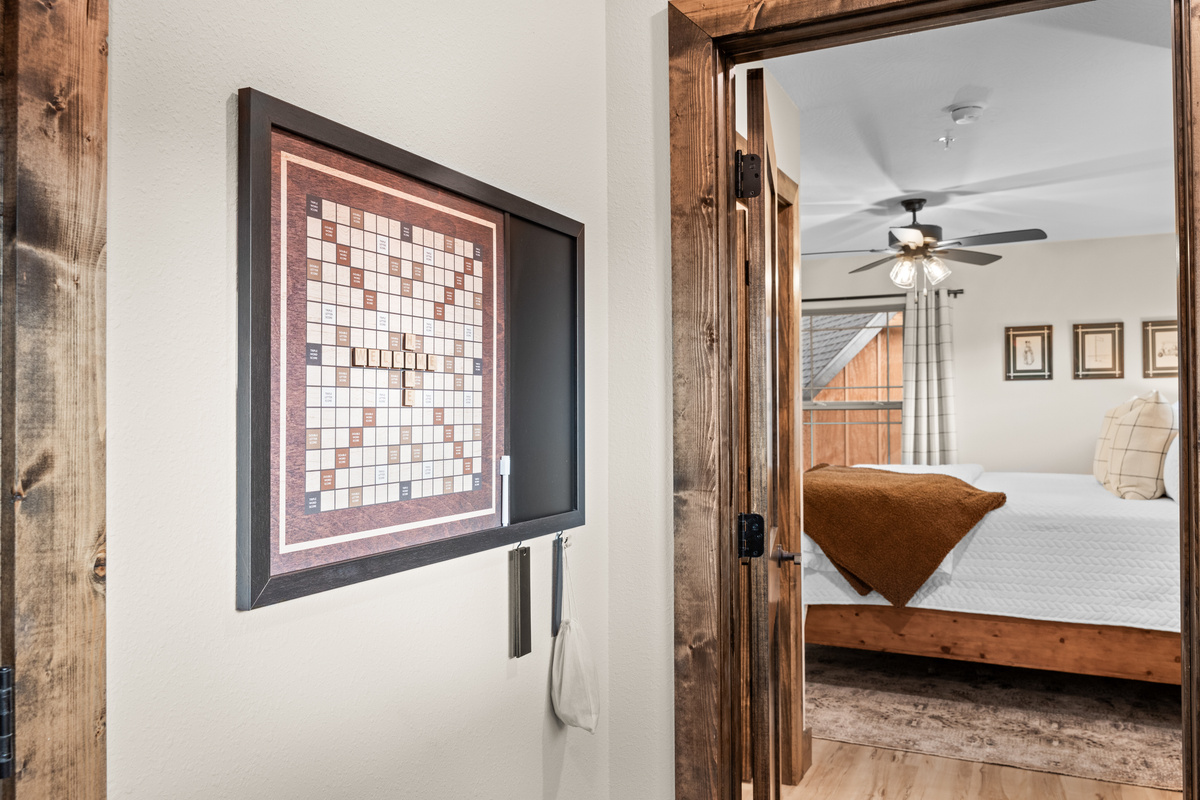 Step past the giant Scrabble board into a bright king room dressed in windowpane linens.