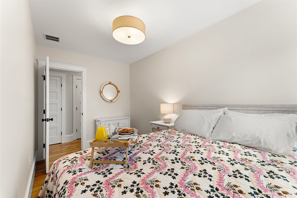 Comfort and calm await in the second bedroom with a queen bed and soft linens.