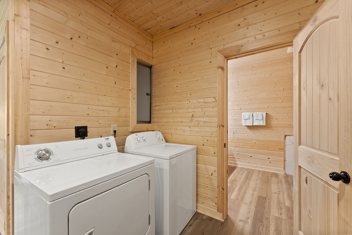 Laundry room equipped with a washer and dryer for light packing and longer stays.