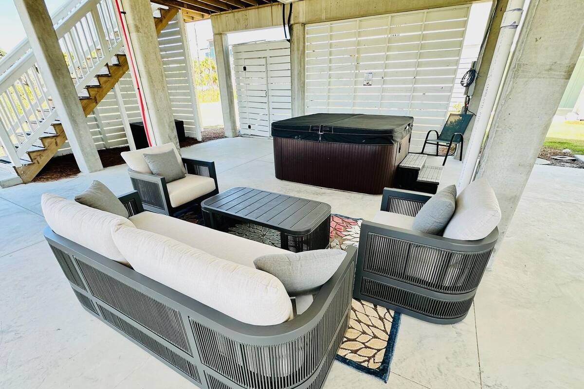 Relax on the cozy patio with comfortable seating, perfect for morning coffee, evening cocktails, or unwinding after a day at the beach.