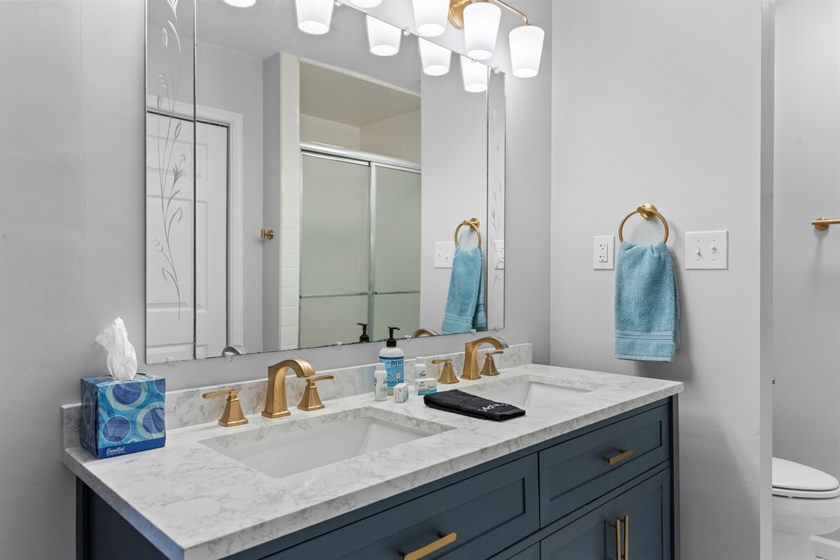 Bathroom Oasis: Enjoy dual sinks, elegant finishes, and refreshing blue accents for your retreat!