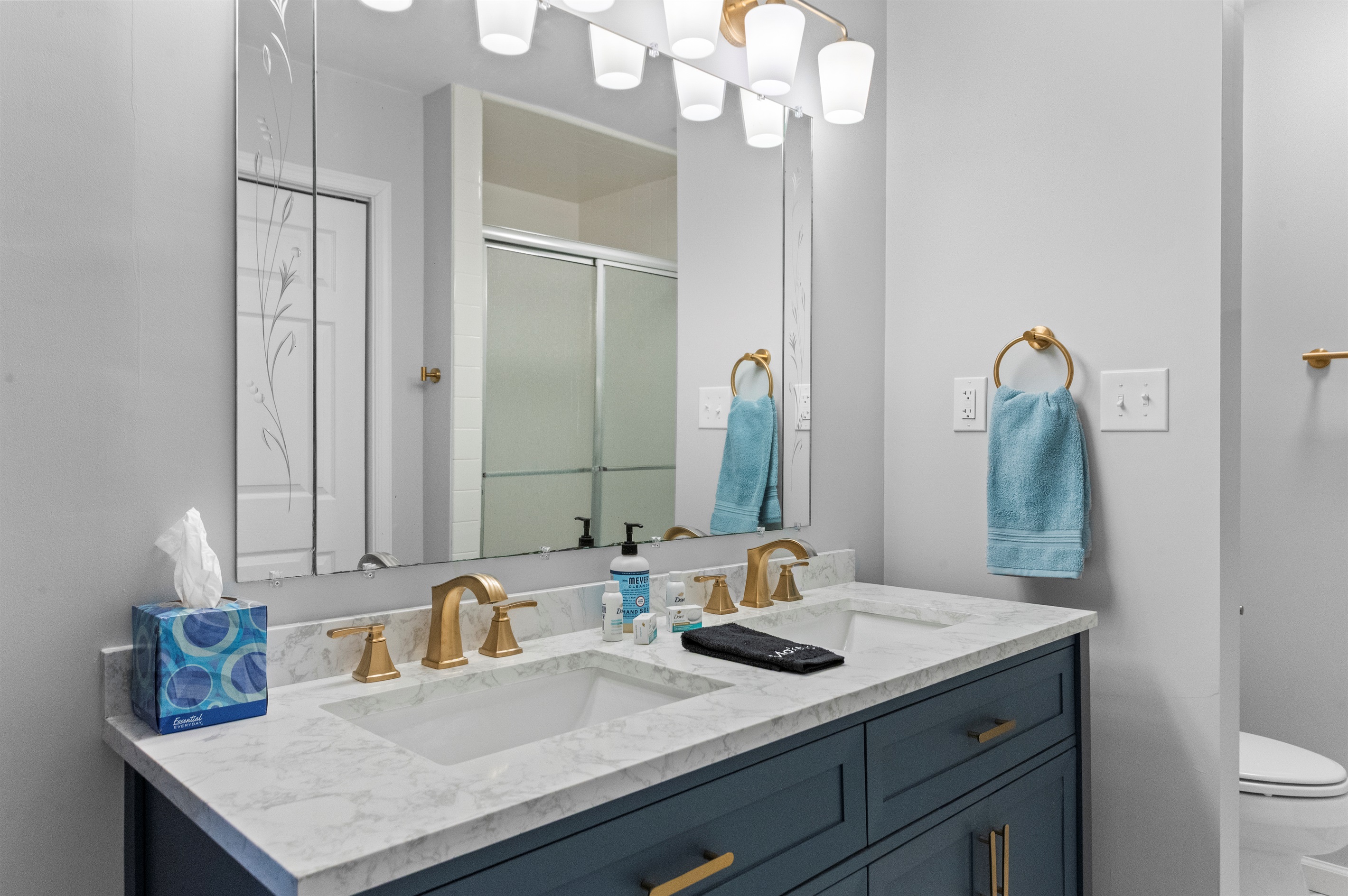 Bathroom Oasis: Enjoy dual sinks, elegant finishes, and refreshing blue accents for your retreat!