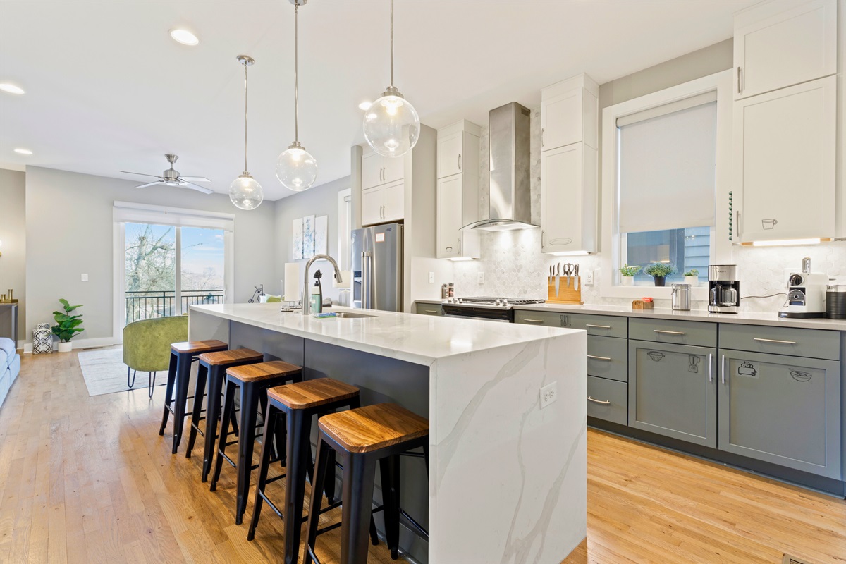 Barstool seating in Casa Tiffani’s sparkling, open-concept kitchen supplements dining seating and is perfect for breakfast, a quick snack, or beverages.