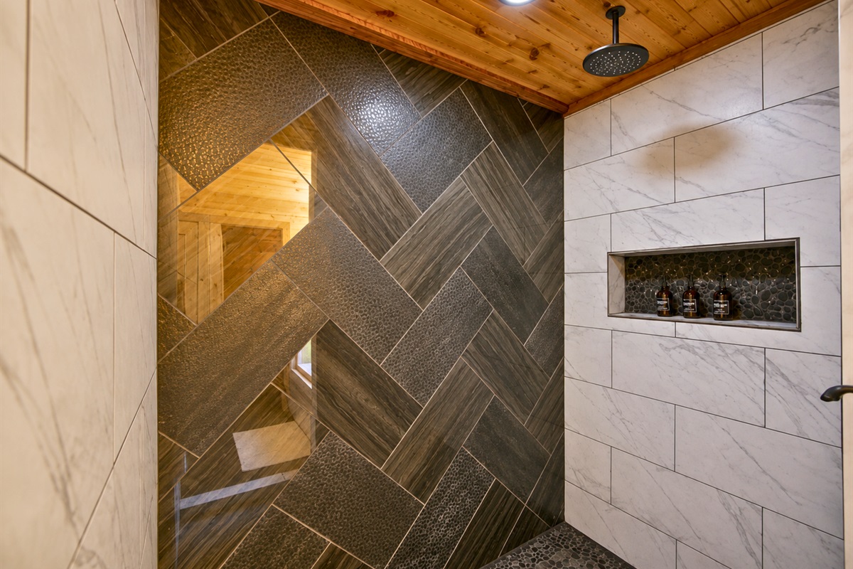 Clean tilework and modern finishes in the walk-in shower add a touch of luxury to the cabin experience.