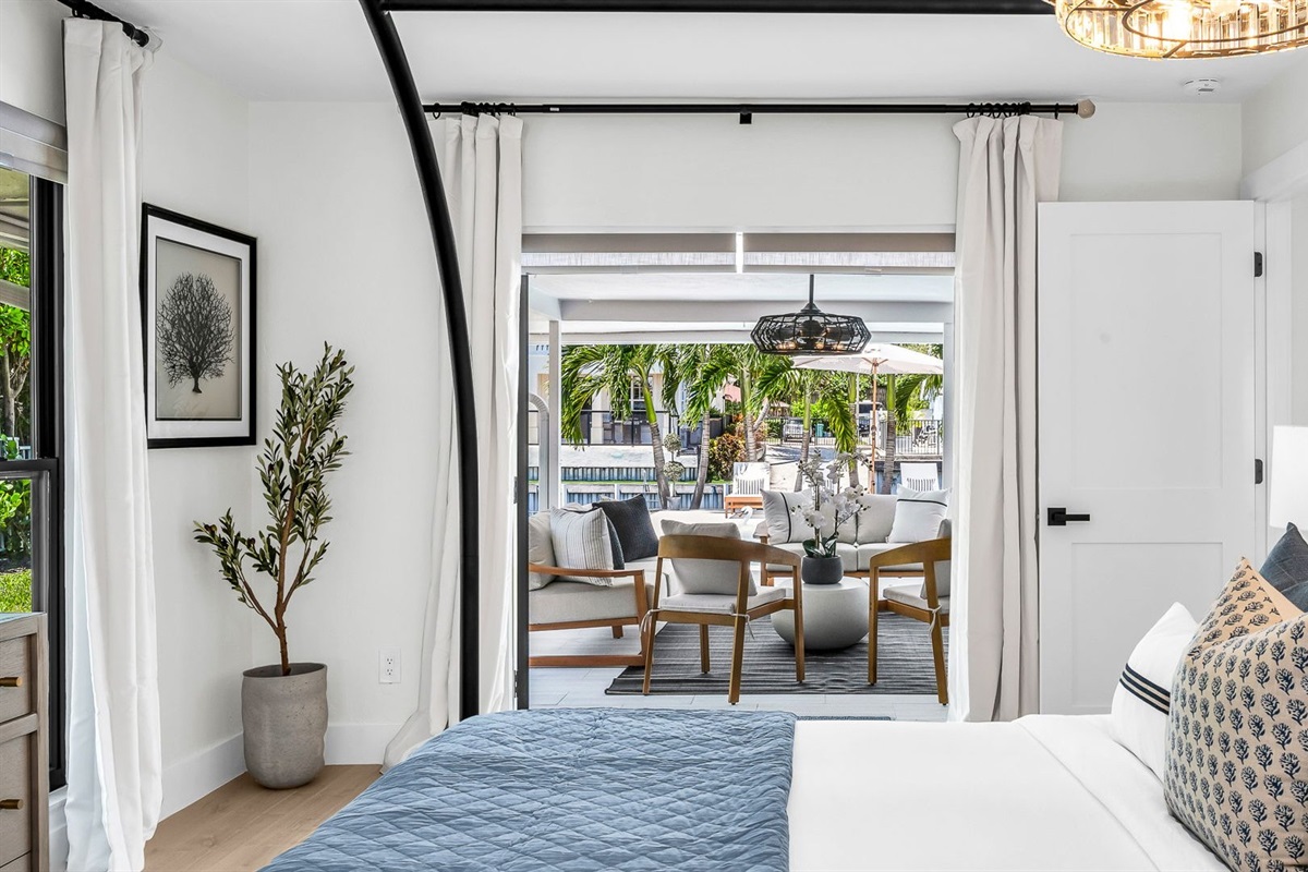 This second primary suite offers a plush king bed, private ensuite bathroom, and walk-in closet for added comfort. Enjoy poolside views and direct access to the outdoor living area, making it the perfect blend of luxury and convenience.
