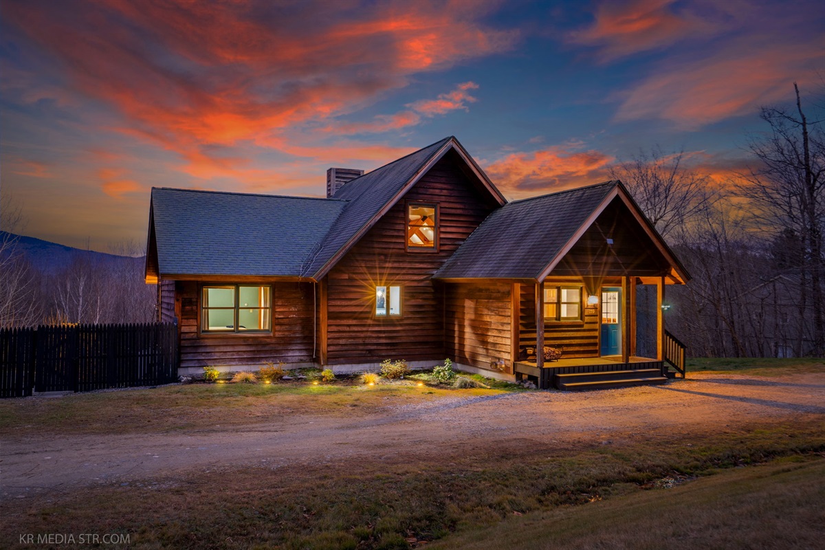 Come home to a glowing mountain cabin where warm lights and peaceful surroundings welcome you back after a full day out.