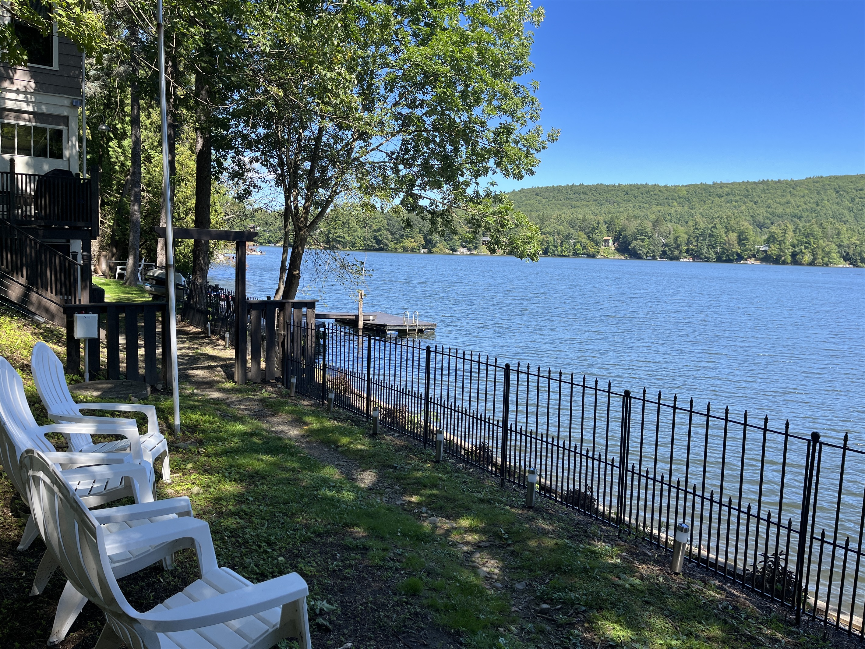 Outside seating at the boathouse, the path to the main house in through the gate.