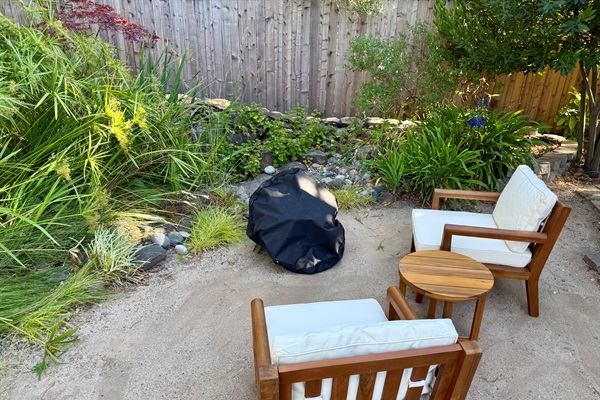 Cozy patio nook w/ chairs & firepit for easy outdoor hangs