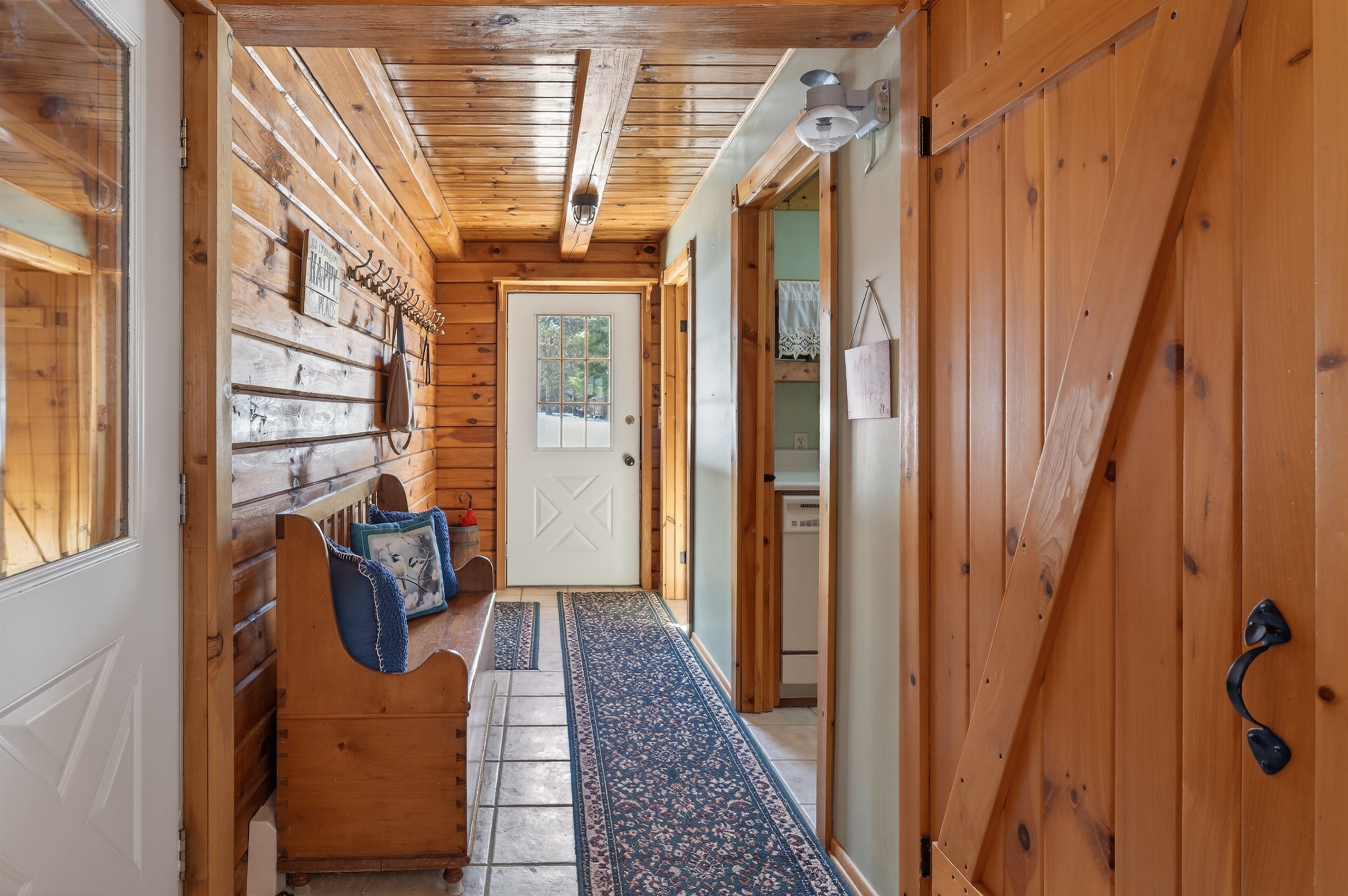 Entry hallway with laundry room and half bath