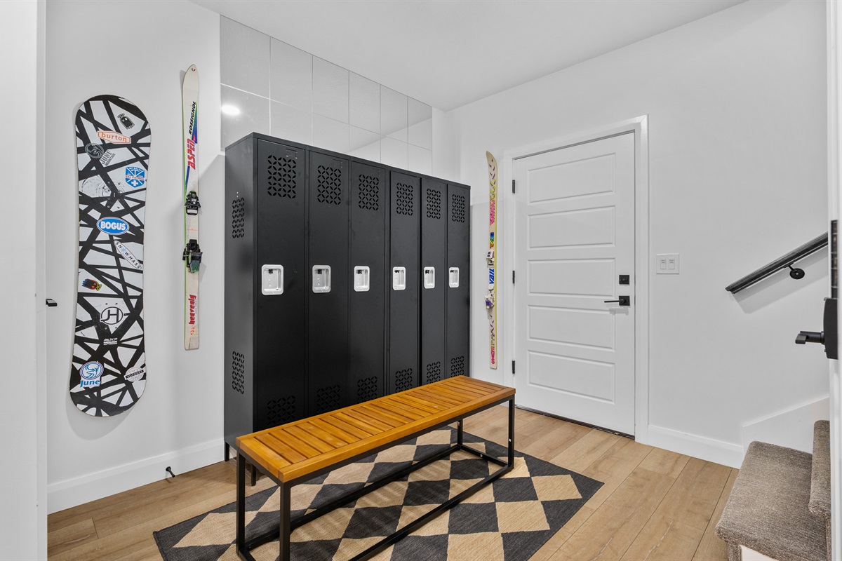 Organized mudroom with secure ski and boot storage for guests.