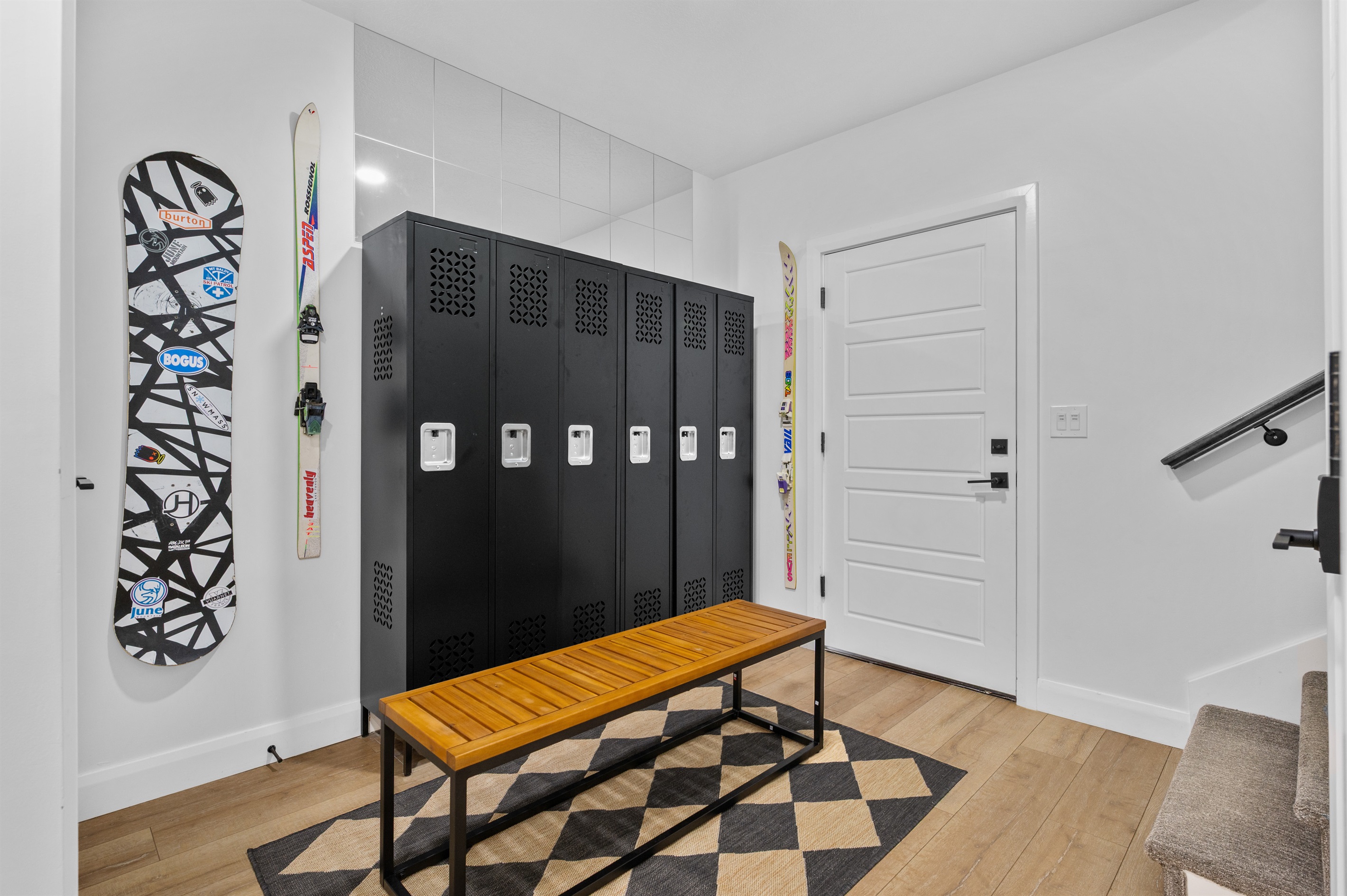 Organized mudroom with secure ski and boot storage for guests.