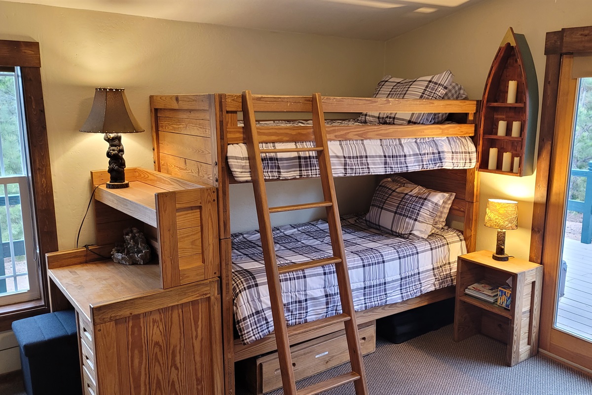 Bunk Bedroom, set up for kids with a stocked toy box, DVDs and VHS kids movies and a TV to play them on.