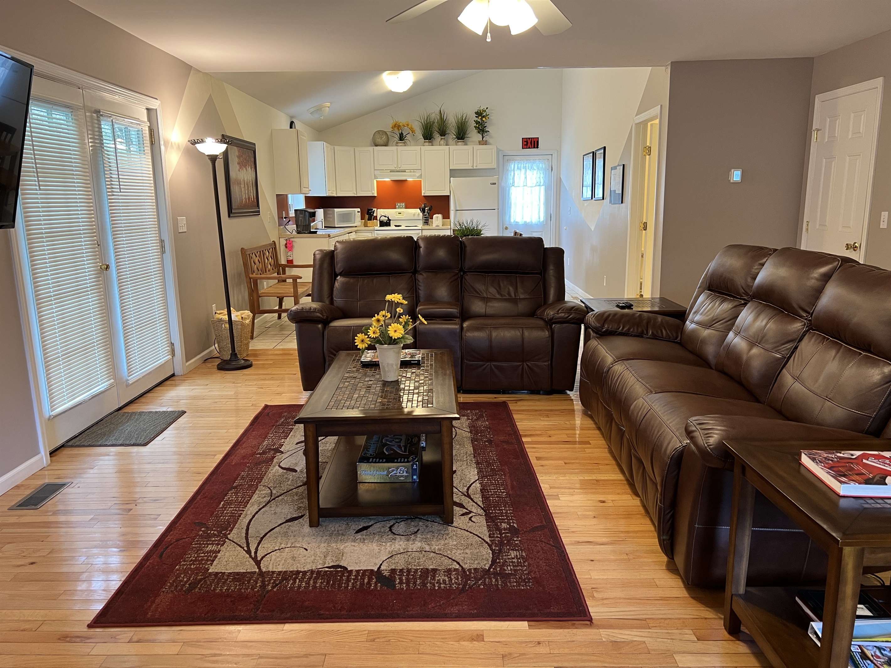 Apartment One living room with open layout to kitchen area.
