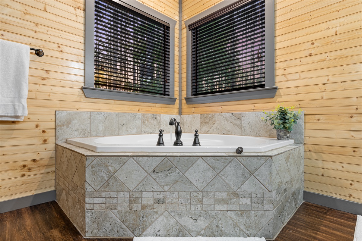 Acadia's ensuite: 2-person whirlpool, walk-in shower, dual vanity, natural light. Relaxation, seclusion, and convenience!