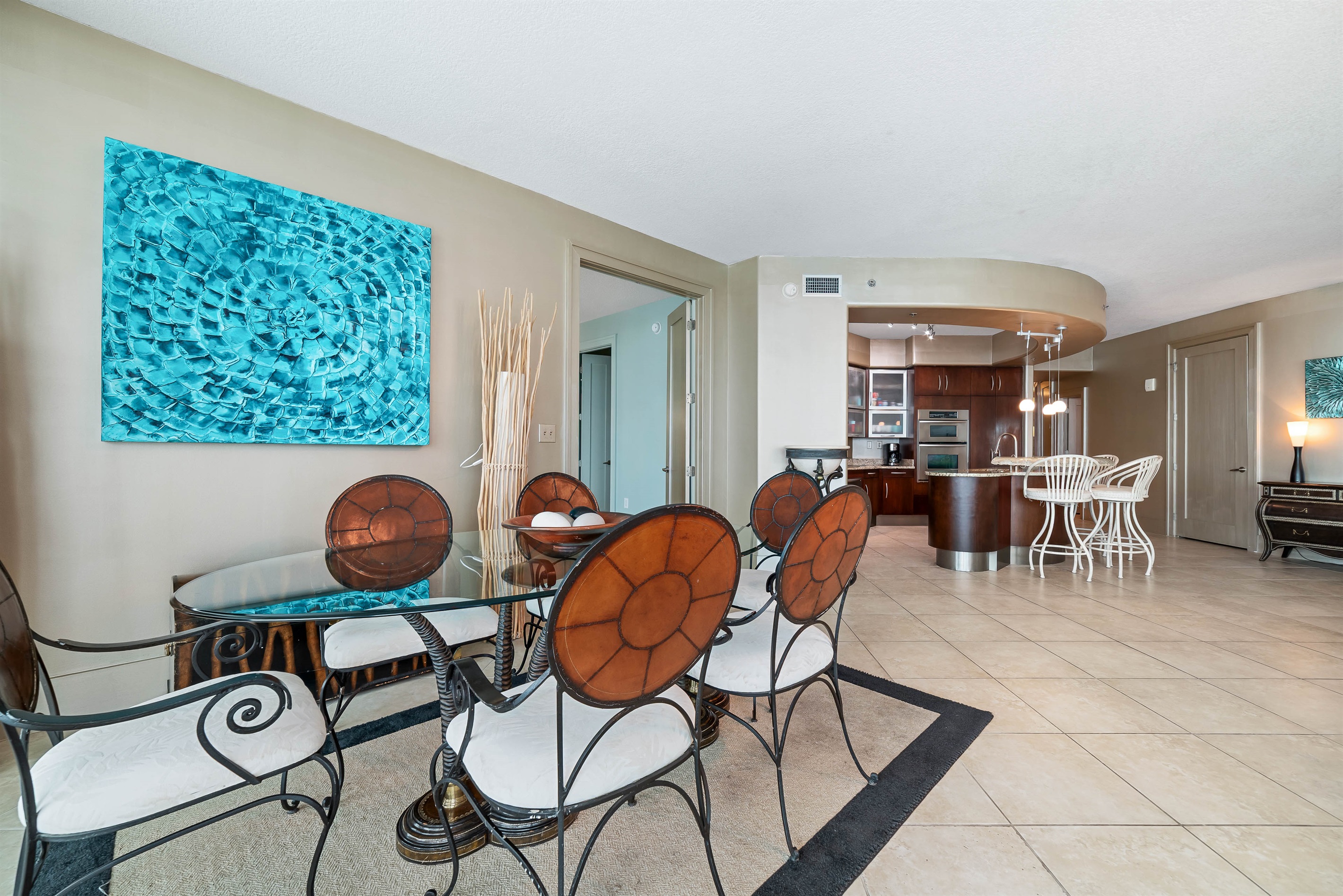Gather around the elegant dining table, ready for memorable meals and conversations in this beautifully appointed bayfront condo.